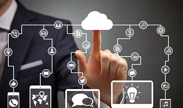 a man in a business suit pointing to a cloud with icons on it