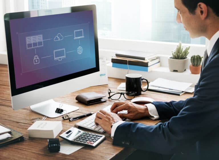 a man sitting at a desk working on a computer