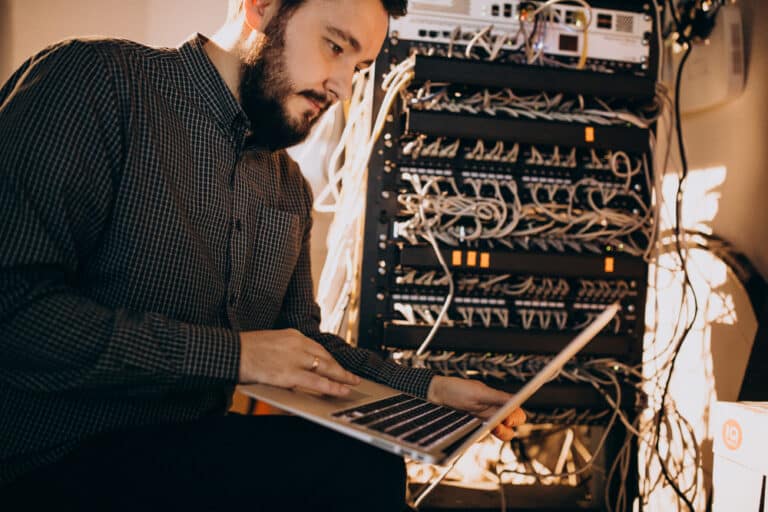 a man sitting in front of a laptop computer